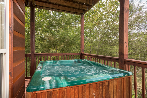 Hot tub on a covered deck at Pigeon Forge View, a 6 bedroom cabin rental located in Pigeon Forge