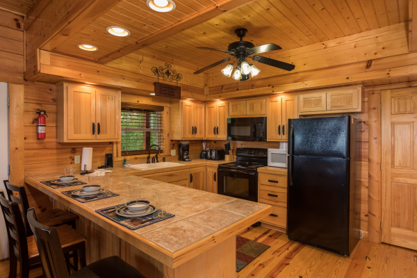 Kitchen with black appliances at Pigeon Forge View, a 6 bedroom cabin rental located in Pigeon Forge