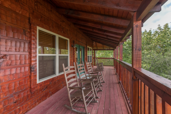 Rocking chairs on a covered deck at Pigeon Forge View, a 6 bedroom cabin rental located in Pigeon Forge