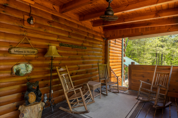 Porch with rocking chairs at Smokies Paradise Lodge, a 5 bedroom cabin rental located in Pigeon Forge