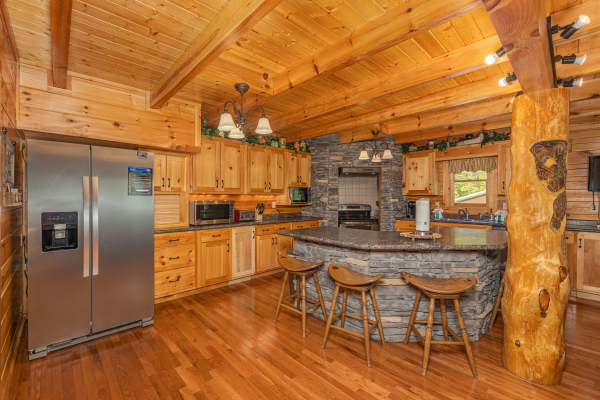 Kitchen with breakfast bar at Smokies Paradise Lodge, a 5 bedroom cabin rental located in Pigeon Forge