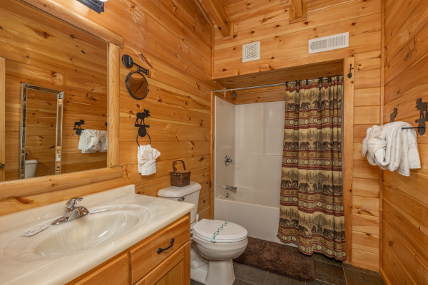 Bathroom with tub and shower at Smokies Paradise Lodge, a 5 bedroom cabin rental located in Pigeon Forge