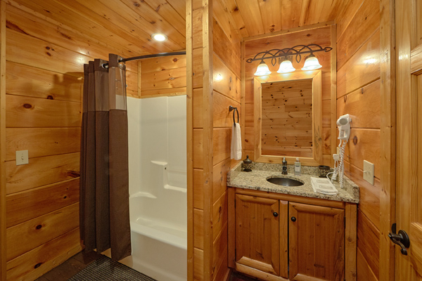 Bathroom with a tub and shower at Makin' Honey, a 1 bedroom cabin rental located in Pigeon Forge