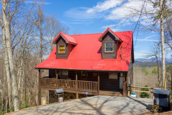 Front exterior of cabin with grill and trash cans at Makin' Honey, a 1 bedroom cabin rental located in Pigeon Forge
