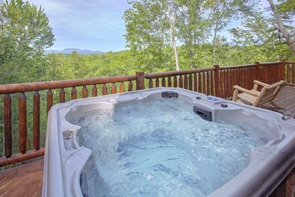 Hot tub overlooking the wooded mountain view at Makin' Honey, a 1 bedroom cabin rental located in Pigeon Forge