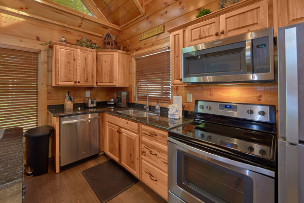 Kitchen with stainless appliances at Makin' Honey, a 1 bedroom cabin rental located in Pigeon Forge