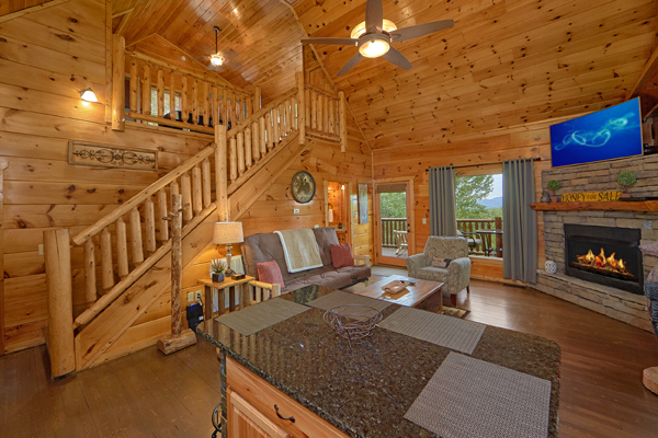 Living room with fireplace and TV at Makin' Honey, a 1 bedroom cabin rental located in Pigeon Forge