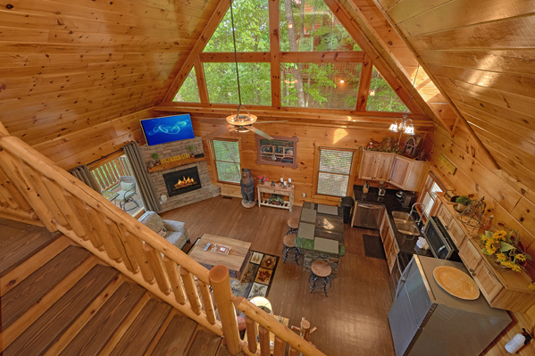 Looking down onto the open concept main floor at Makin' Honey, a 1 bedroom cabin rental located in Pigeon Forge
