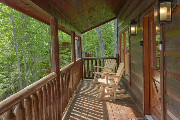 Covered porch with rocking chairs at Makin' Honey, a 1 bedroom cabin rental located in Pigeon Forge