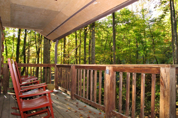 Front covered porch with rocking chairs at Wild at Heart, a 1 bedroom cabin rental located in Gatlinburg