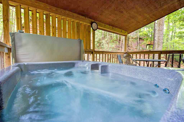 Hot tub on a covered deck at Wild at Heart, a 1 bedroom cabin rental located in Gatlinburg