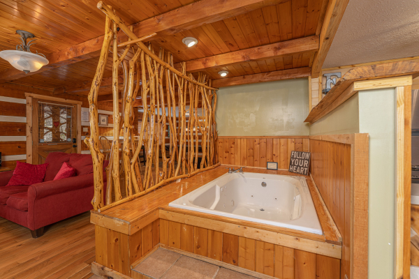 Jacuzzi in the living room at Wild at Heart, a 1 bedroom cabin rental located in Gatlinburg