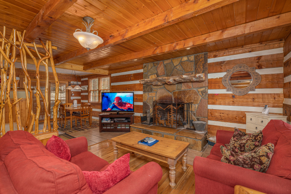 Living room with fireplace and TV at Wild at Heart, a 1 bedroom cabin rental located in Gatlinburg
