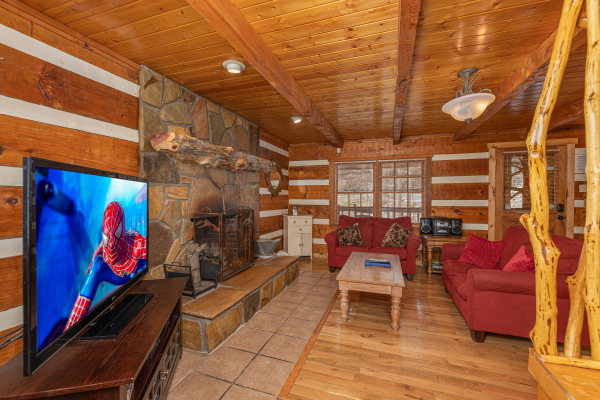 Living room with TV and fireplace at Wild at Heart, a 1 bedroom cabin rental located in Gatlinburg