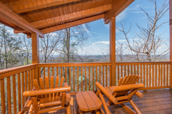 Deck with seasonal views and rocking chairs at Ella-Vation, a 3 bedroom cabin rental located in Gatlinburg