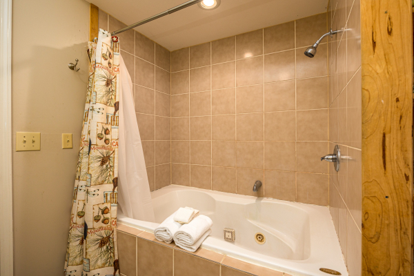Soaker tub and shower combo at Brink of Heaven, a 2 bedroom cabin rental located in Gatlinburg