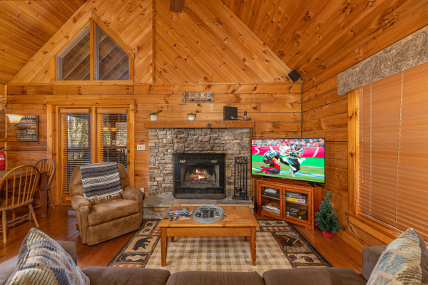 Living room with fireplace and TV at Golden Memories, a 1 bedroom cabin rental located in Pigeon Forge