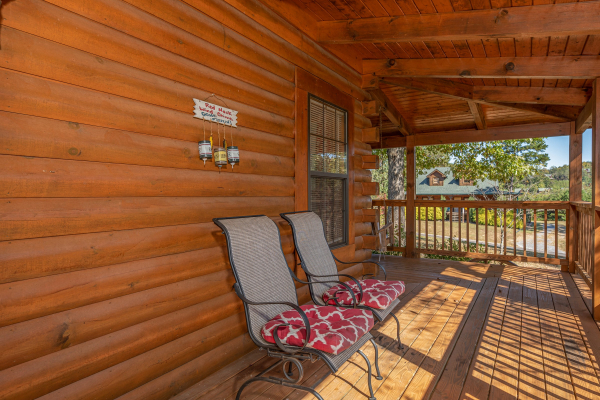 Chairs on a covered deck at Bearadise 4 Us, a 3 bedroom cabin rental located in Pigeon Forge