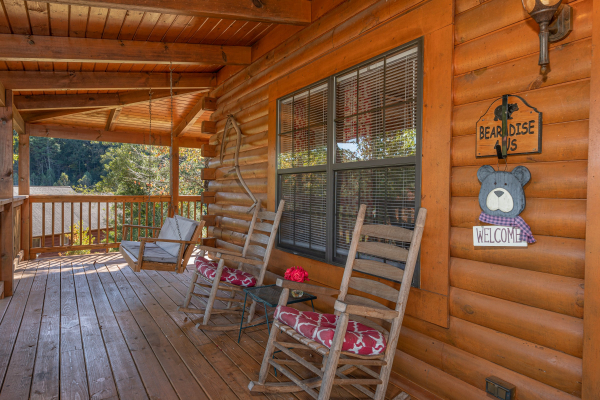 Front porch with swing and rocking chairs at Bearadise 4 Us, a 3 bedroom cabin rental located in Pigeon Forge