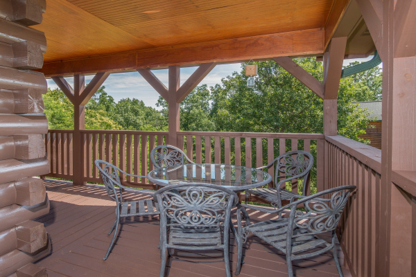 Dining table for five on the deck at Moose Lodge, a 4 bedroom cabin rental located in Sevierville