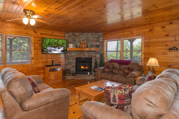 Living room with a fireplace and TV at Moose Lodge, a 4 bedroom cabin rental located in Sevierville 