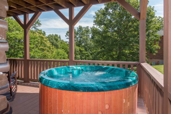 Hot tub on a covered deck at Moose Lodge, a 4 bedroom cabin rental located in Sevierville