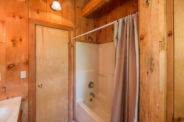 Bathroom with a tub and shower at Mountain Glory, a 1 bedroom cabin rental located in Pigeon Forge