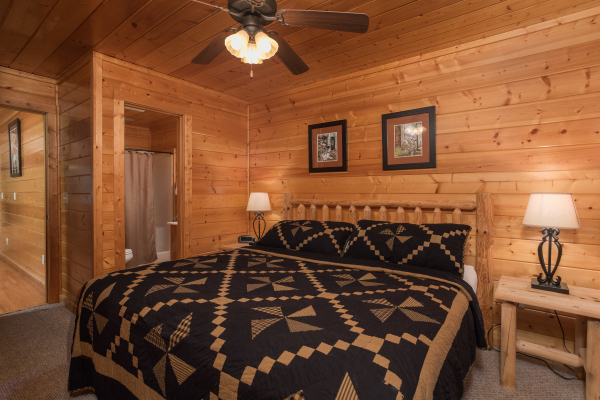 Bedroom with a log bed, night stands, and lamps at Kick Back & Relax! A 4 bedroom cabin rental located in Pigeon Forge