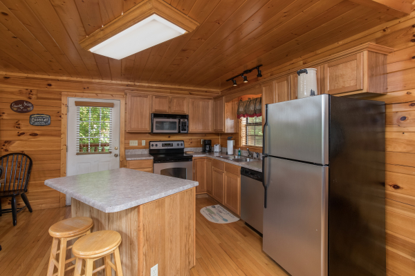 Kitchen with stainless appliances Kick Back & Relax! A 4 bedroom cabin rental located in Pigeon Forge