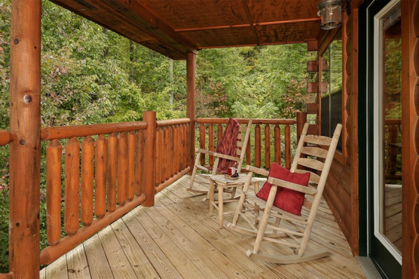 Two deck rockers looking into the woods at Family Ties Lodge, a 4-bedroom cabin rental located in Pigeon Forge