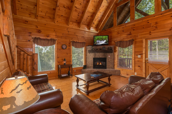 Living room with fireplace and TV at A Beautiful Memory, a 4 bedroom cabin rental located in Pigeon Forge