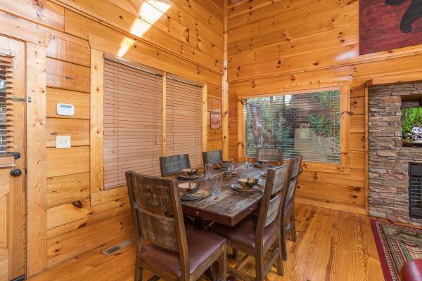Dining room with table for 6 at Graceland, a 4-bedroom cabin rental located in Pigeon Forge