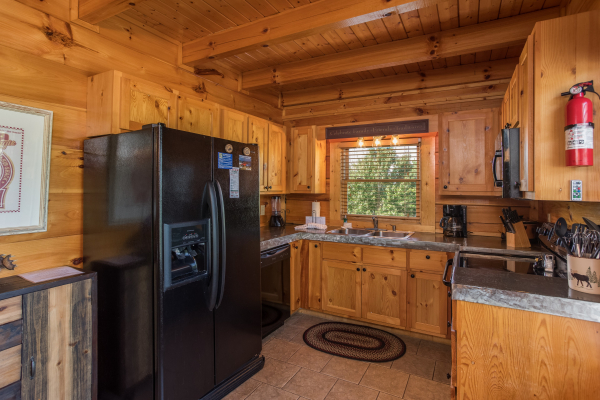 Kitchen with black appliances at Graceland, a 4-bedroom cabin rental located in Pigeon Forge