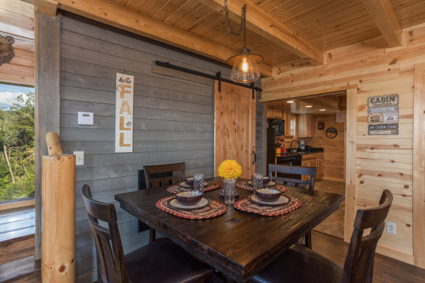 Dining table for four at The Sugar Shack, a 2 bedroom cabin rental located in Pigeon Forge