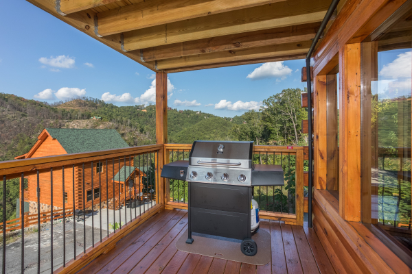 Grill on a covered deck at The Sugar Shack, a 2 bedroom cabin rental located in Pigeon Forge