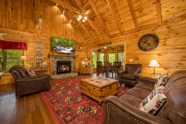 Living room with flat screen on wall above fireplace at Bearfoot Adventure