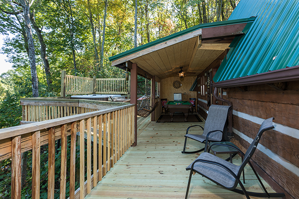 Deck with covered areas and hot tub area at Soaring Heights, a 3 bedroom cabin rental located in Gatlinburg