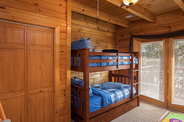 Room with bunk bed and deck access at Lake Life, a 4 bedroom cabin rental located in Sevierville