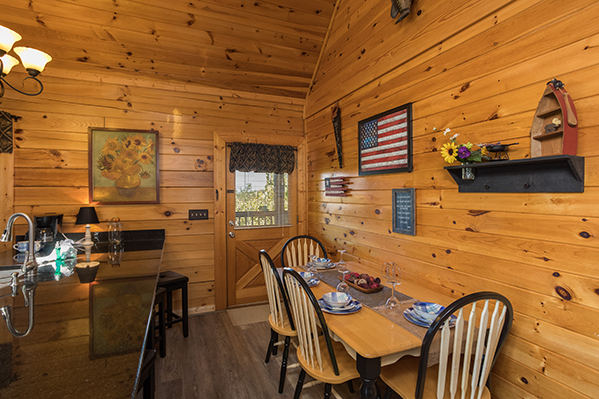 Dining table for four just off the main kitchen at Lake Life, a 4 bedroom cabin rental located in Sevierville