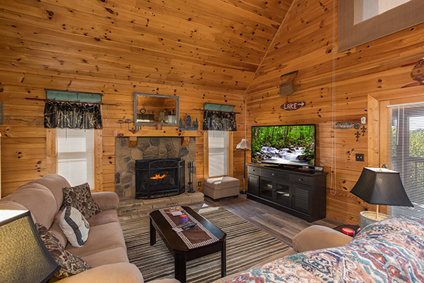 Living room with a fireplace and TV at Lake Life, a 4 bedroom cabin rental located in Sevierville