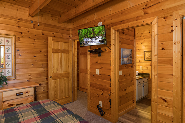 Wall mounted TV and en suite bath at Lake Life, a 4 bedroom cabin rental located in Sevierville