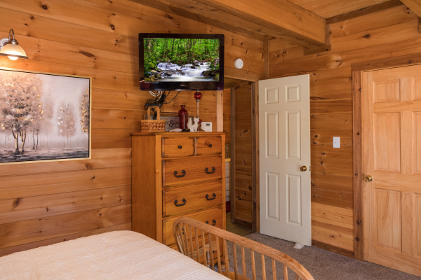 Dresser and TV in a bedroom at Living on Love, a 2 bedroom cabin rental located in Pigeon Forge