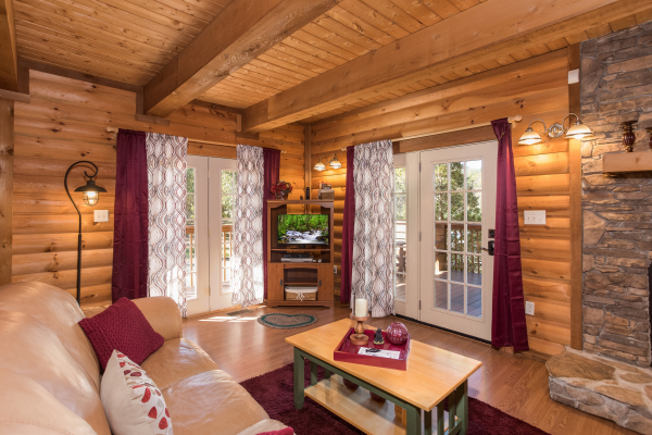 Living room with a TV at Living on Love, a 2 bedroom cabin rental located in Pigeon Forge