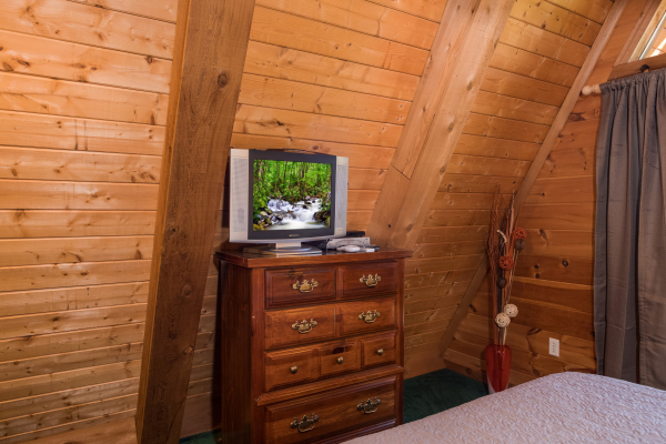 Dresser and TV in the bedroom at Living on Love, a 2 bedroom cabin rental located in Pigeon Forge