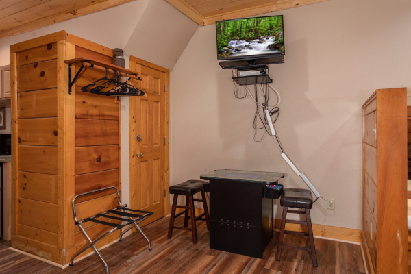 Arcade and TV in the lower living room at Starry Starry Night #725, a 2 bedroom cabin rental located in Pigeon Forge
