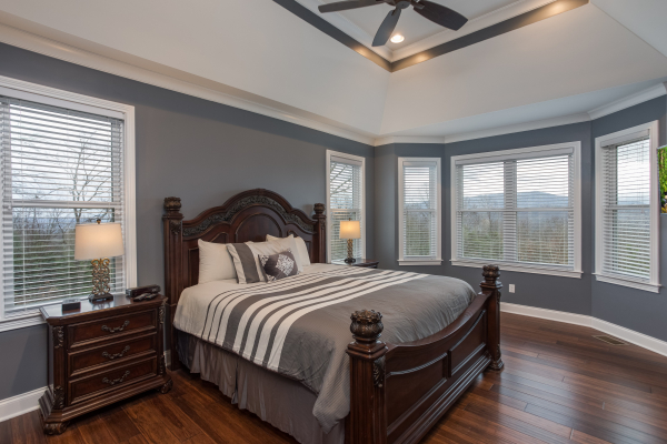 Bedroom with a king bed, night stands, and lamps at Summit Glory, a 5 bedroom cabin rental located in Pigeon Forge