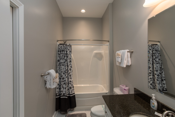 Bathroom with a tub and shower at Summit Glory, a 5 bedroom cabin rental located in Pigeon Forge