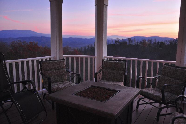 Fire pit on the deck at sunset at Summit Glory, a 5 bedroom cabin rental located in Pigeon Forge
