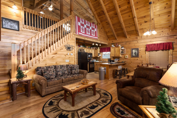 Living room with sofa and chair at Bootlegger's Bounty, a 1-bedroom cabin rental located in Pigeon Forge