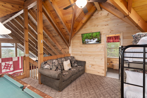 Sofa in the loft at Bootlegger's Bounty, a 1-bedroom cabin rental located in Pigeon Forge
